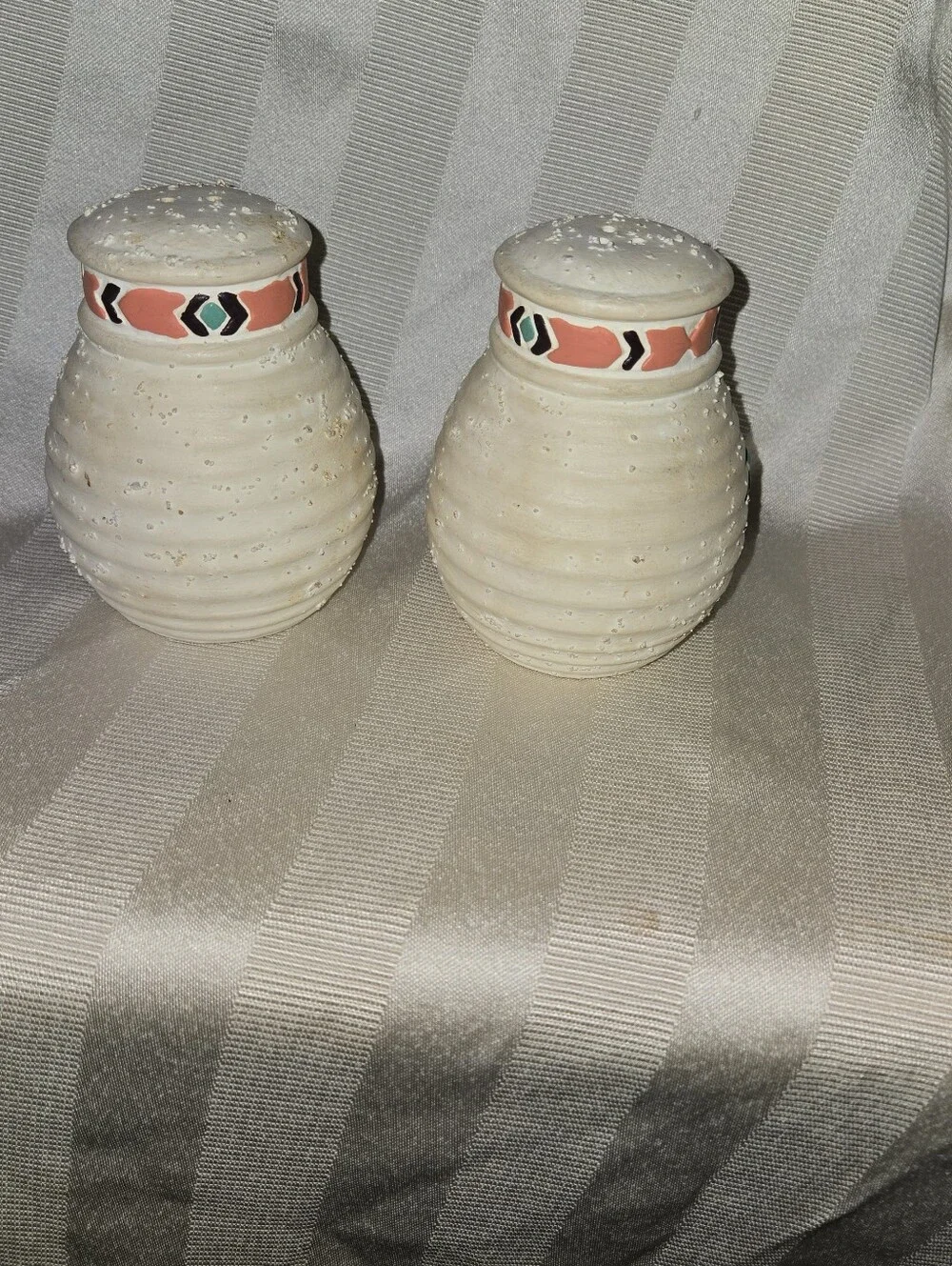 Handcrafted Southwestern Salt and Pepper Shakers with Teal and Coral Accents.
